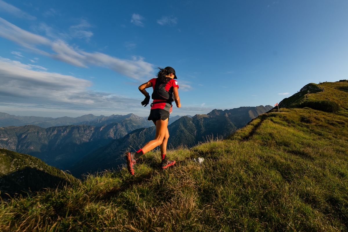 Woman running along a mountain ridge on a trail run