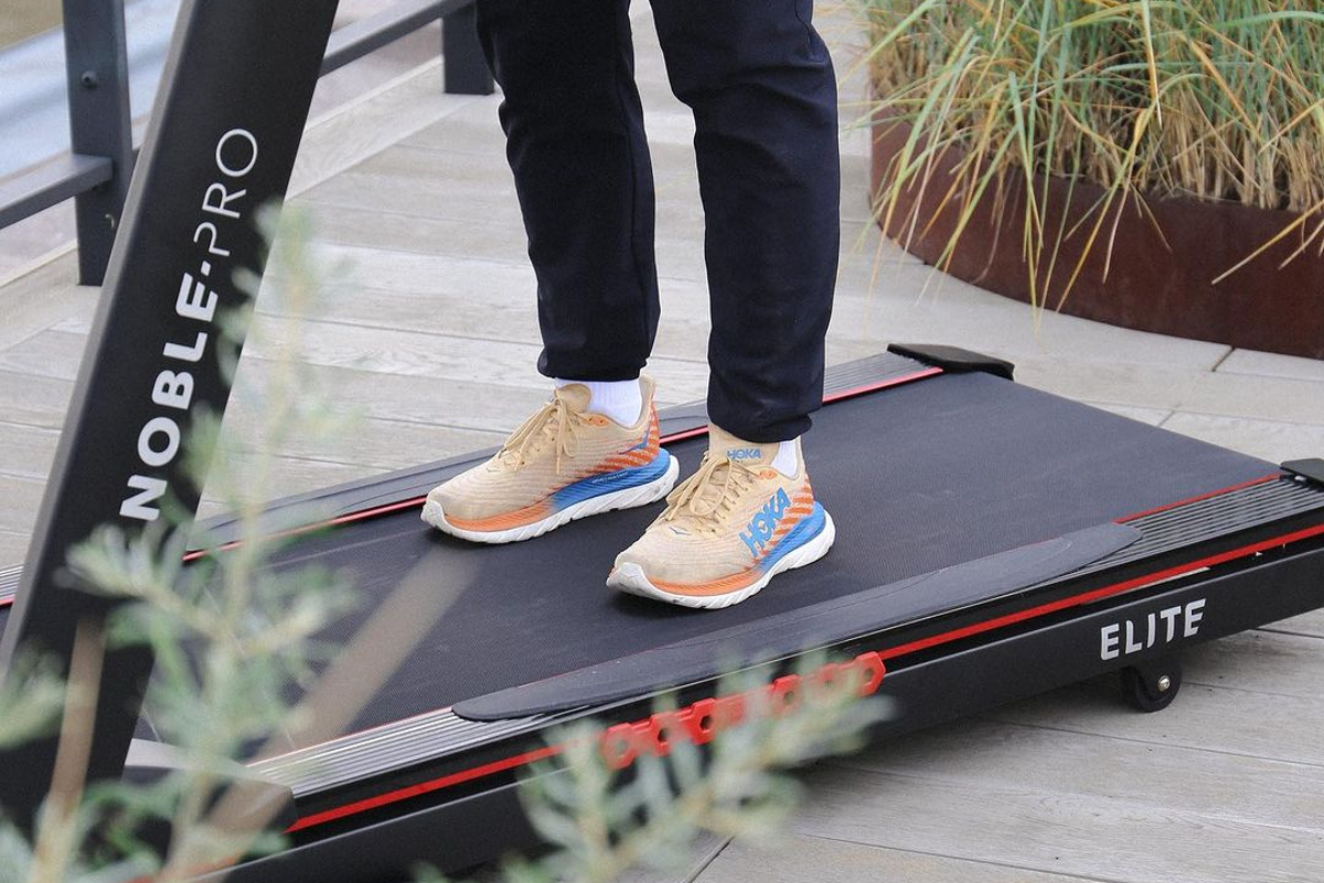 Runner standing on a smart treadmill