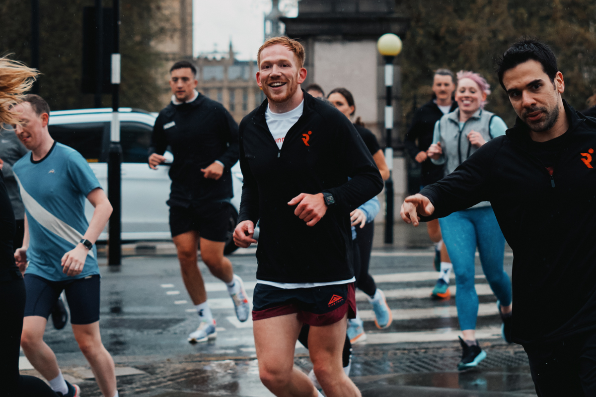 Group of happy runners in the rain on the streets of London
